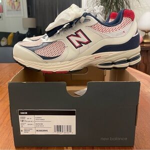 Brand new men’s white New Balance 2002R with removable pouches.  Size 10.5